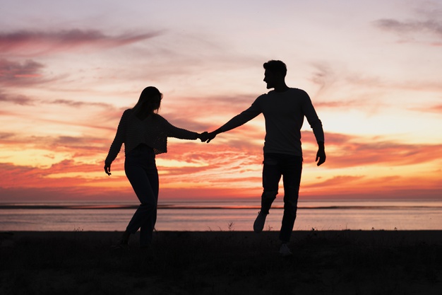 long-shot-couple-holding-hands-sundown_23-2148297686